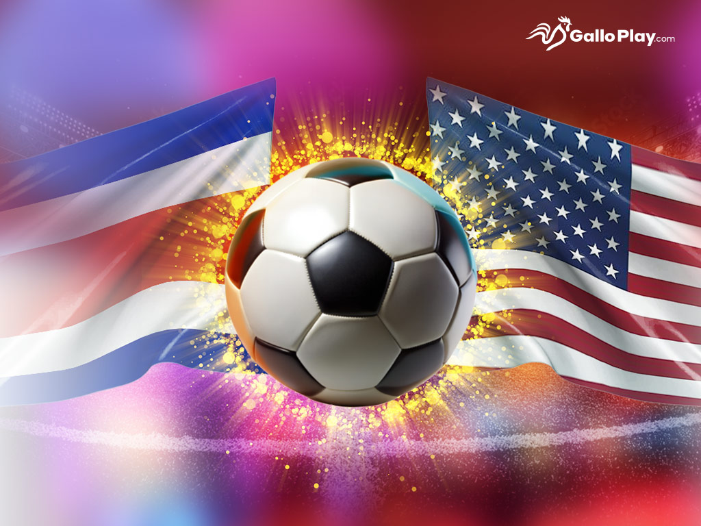 La imagen muestra un balón de fútbol en el centro, rodeado de un efecto explosivo de luz, con las banderas de Costa Rica y Estados Unidos a los lados. El logotipo de GalloPlay aparece en la esquina superior, destacando la temática de apuestas y el evento futbolístico.